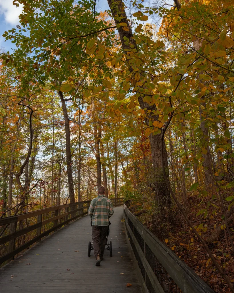guy walking on boardwalk 